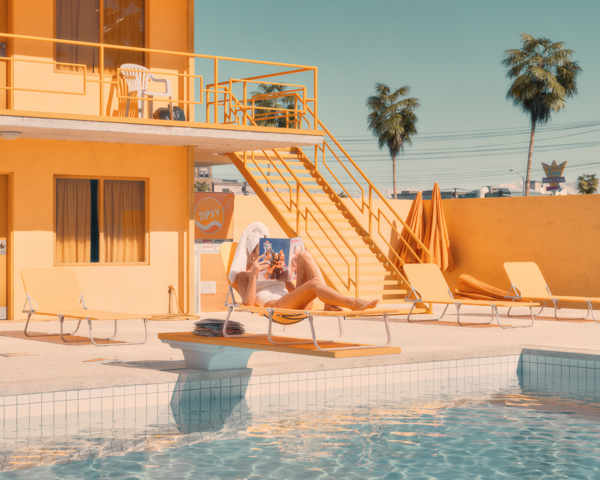 A woman reclining beside a swimming pool in a sunlit yellow motel courtyard with palm trees