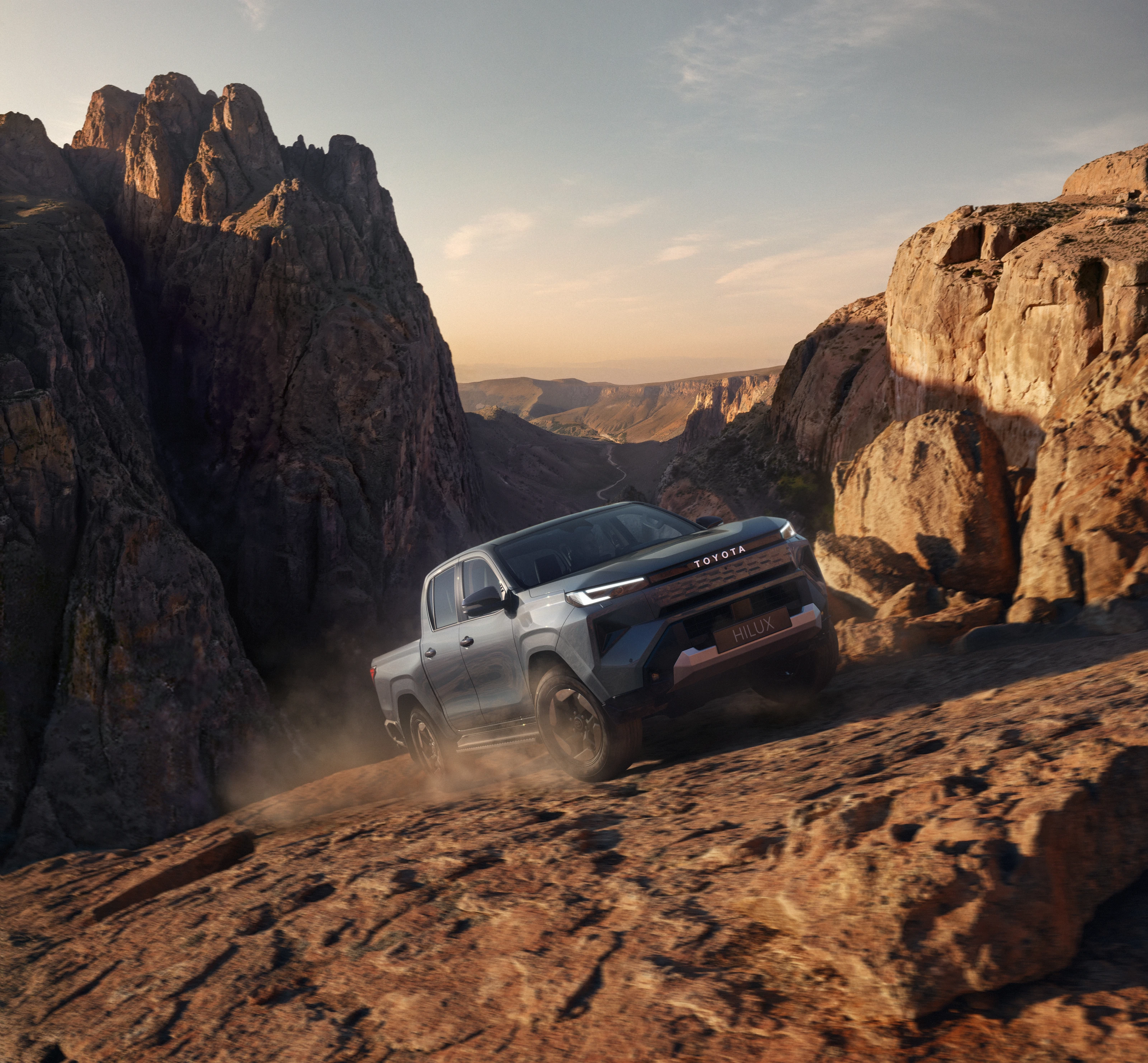 CGI Toyota Hilux climbing a rocky slope above a canyon